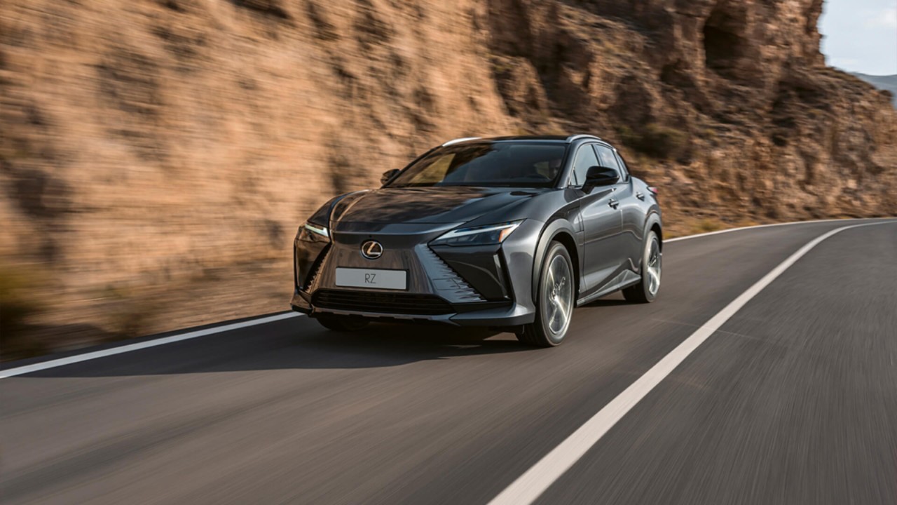 Lexus RZ driving along a rockface